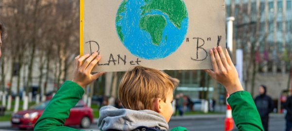 Kid holding a sign about the planet